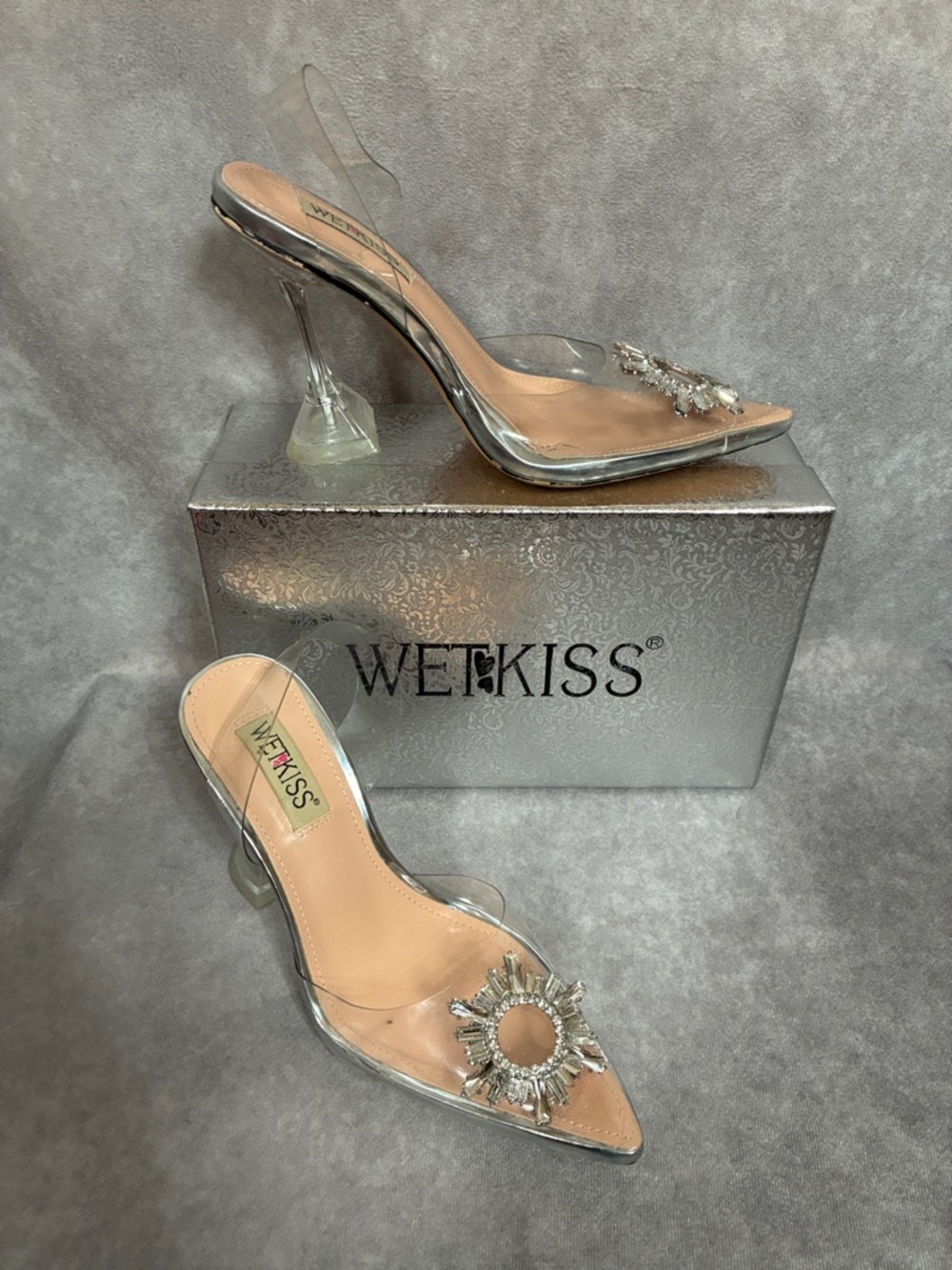 Wetkiss Clear Pointed Slingback Heels with Silver Sunburst Accent